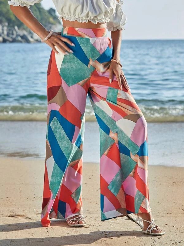 Pantaloni a gamba larga stampati con motivo geometrico e slogan