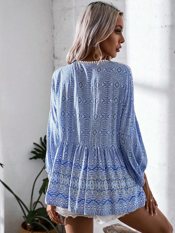 Camicetta peplum stampato all over manica a lanterna